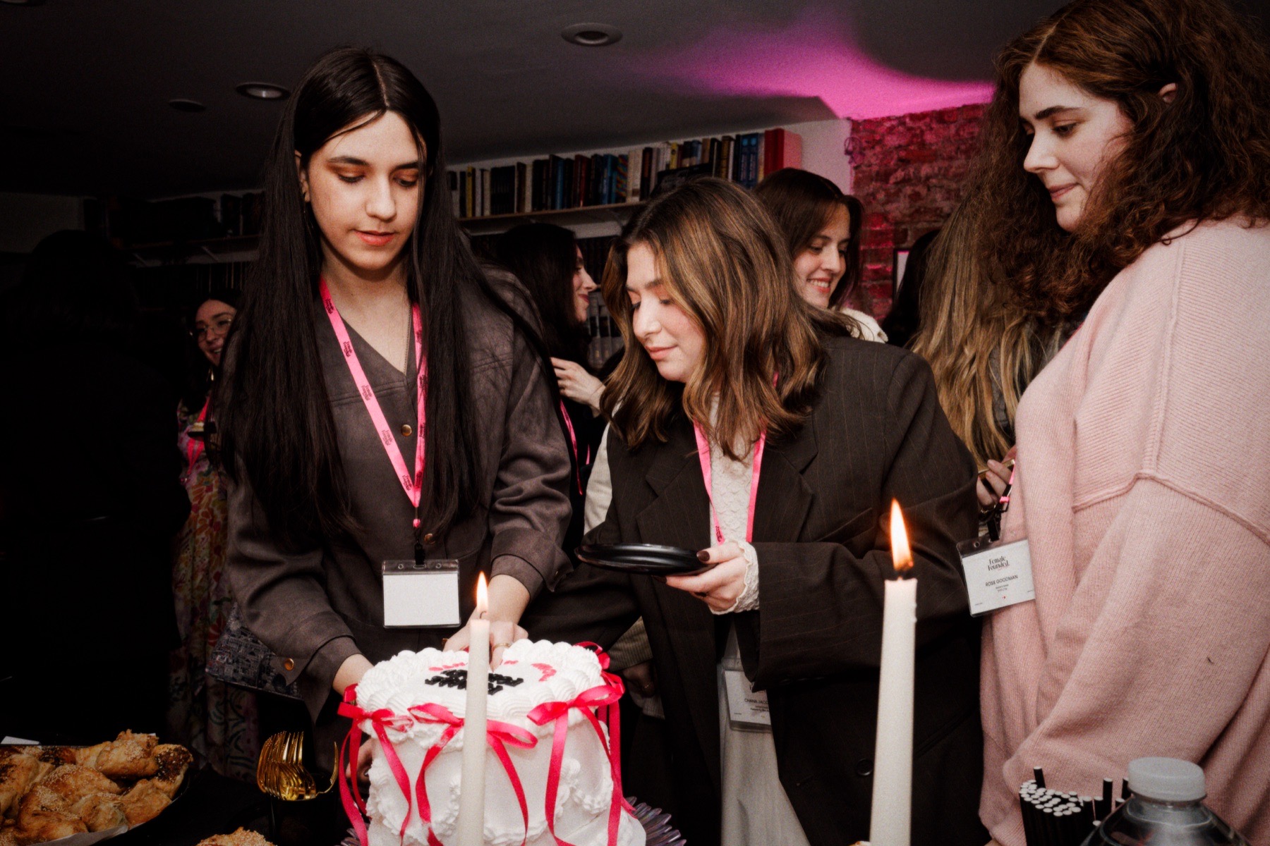 Guests gathering around the Female Founded launch cake